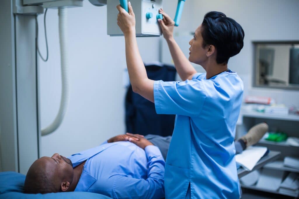 Female doctor sets up the machine to x-ray