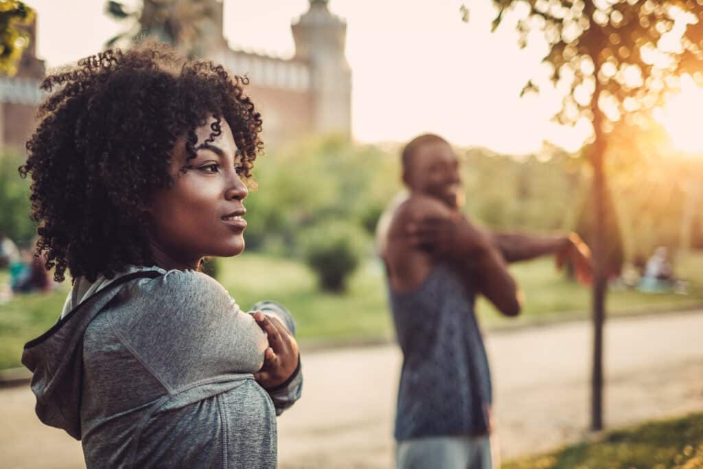 couple doing exercise outdoors