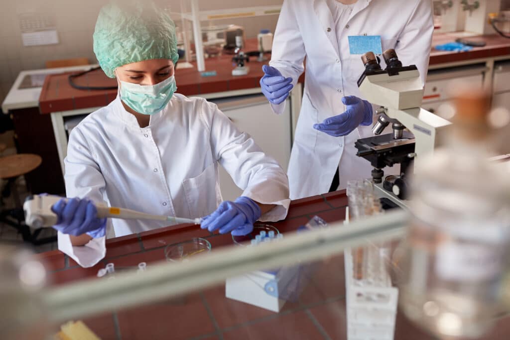 Medical workers examining samples on covid-19 in biochemistry lab